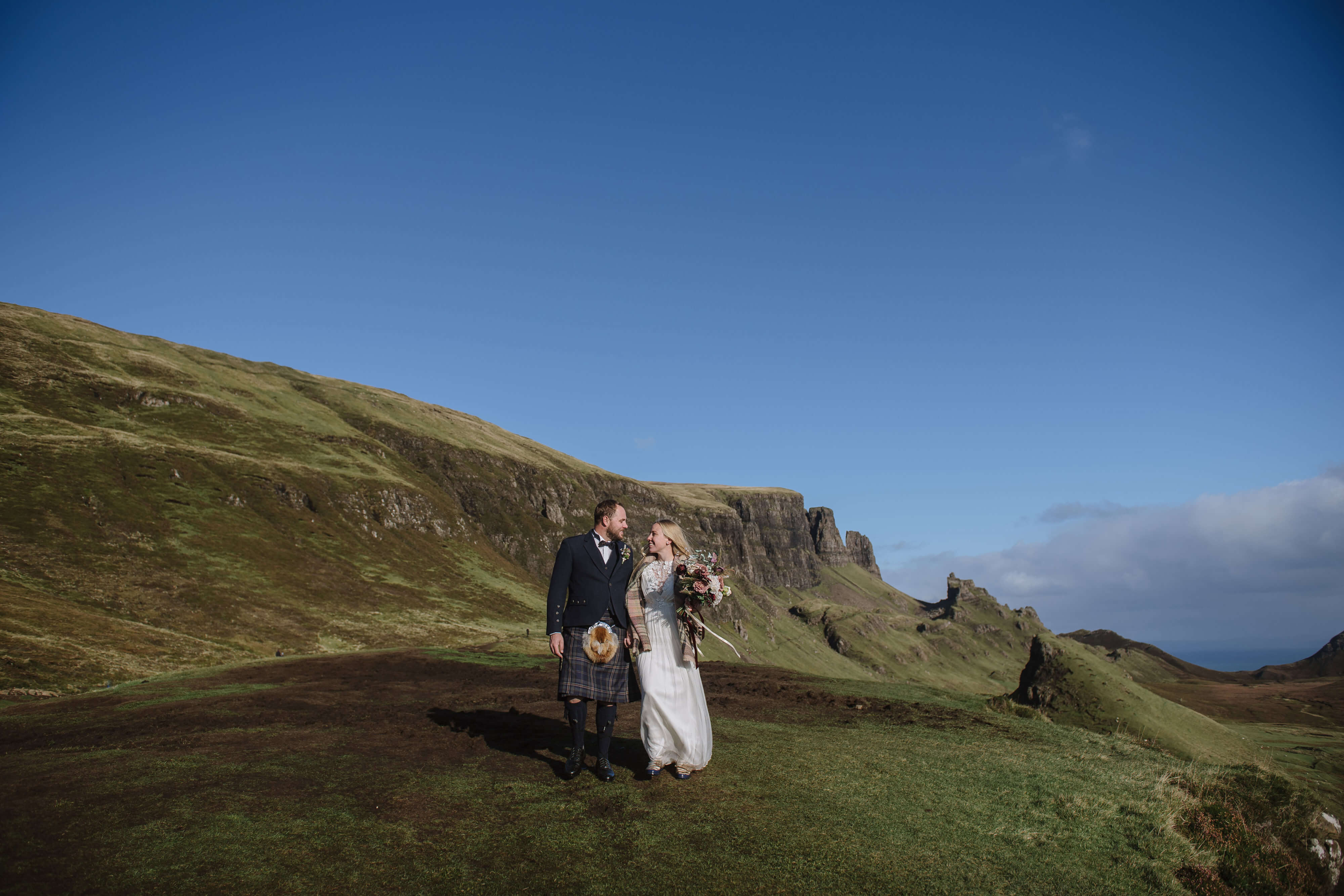 scotland elopement photographer couple walking just married in Skye islands