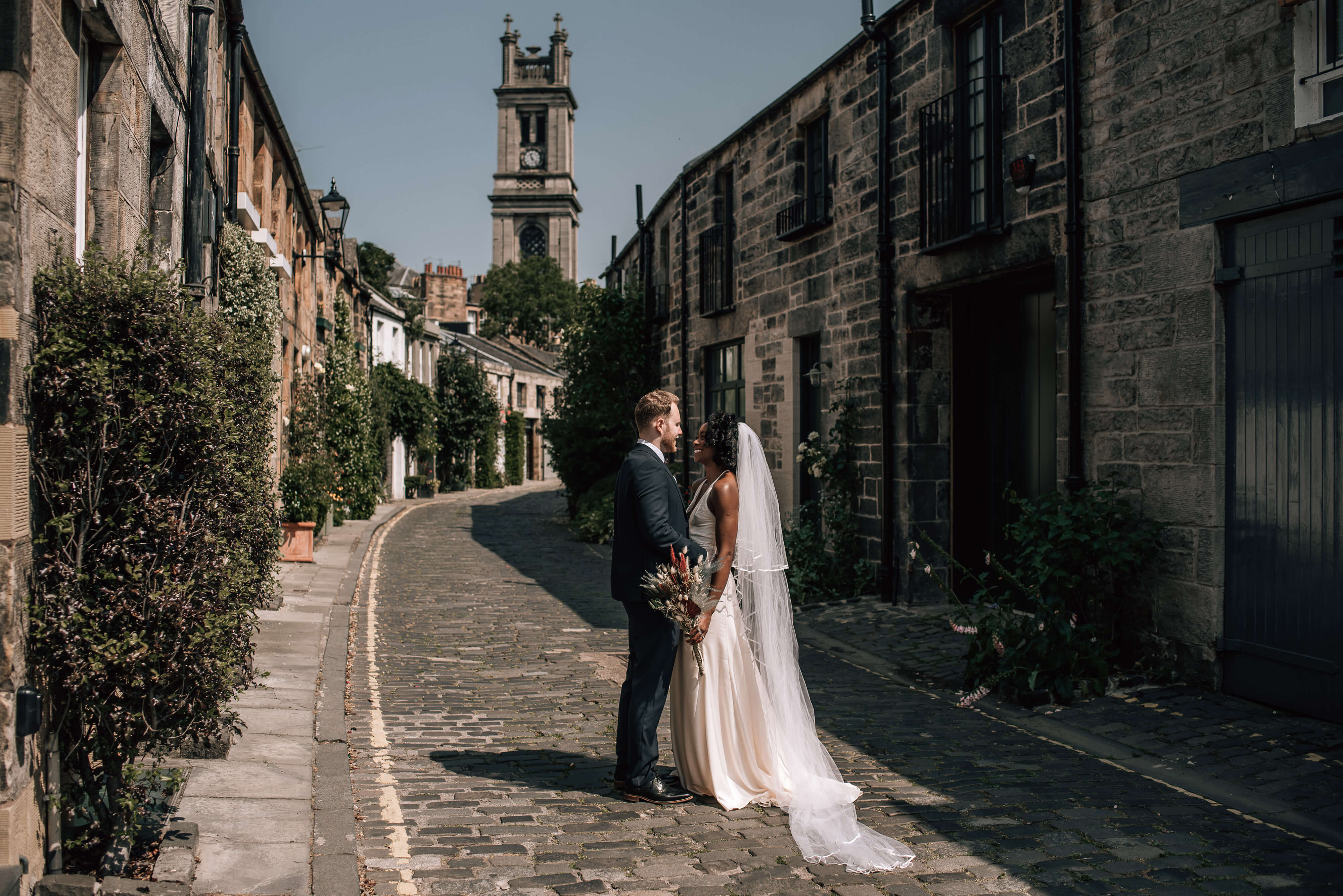 scotland elopement photographer in edinburgh city bride groom old cobbled street on wedding day portraits