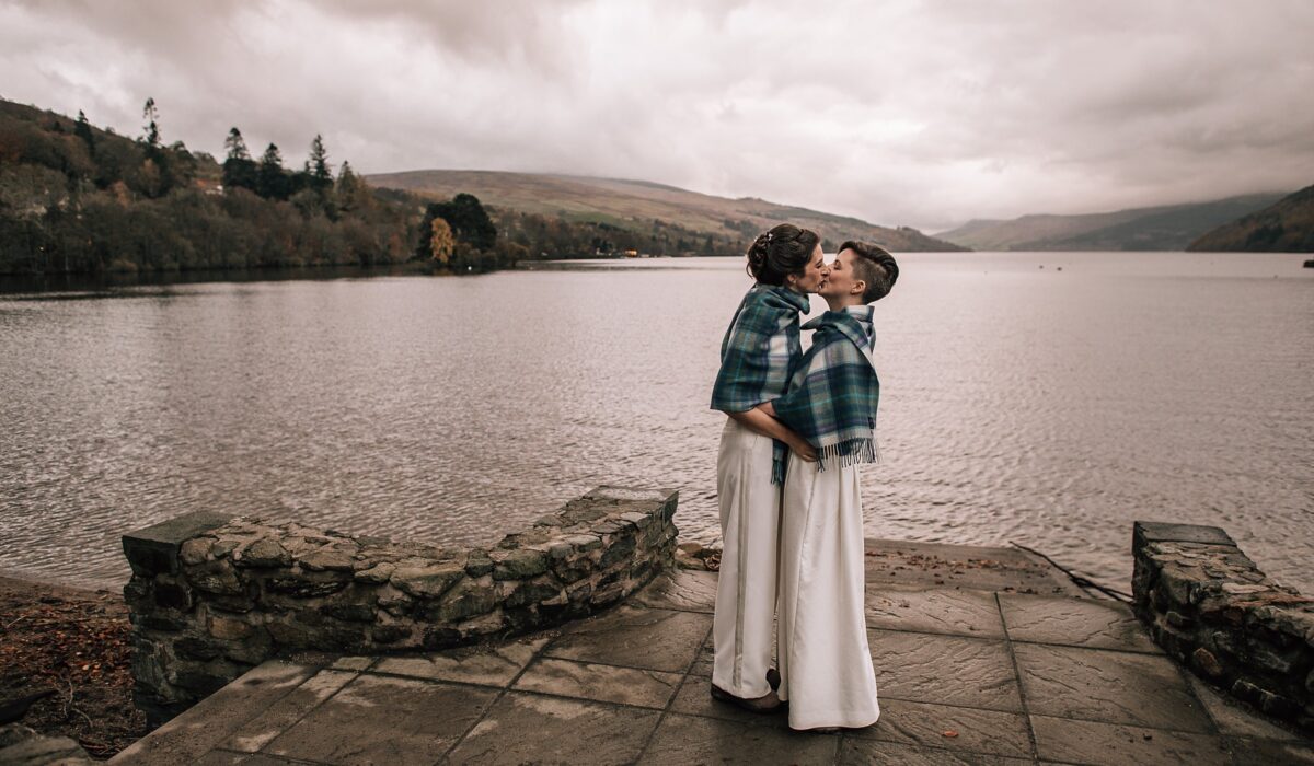 two brides kissing on the shores of a loch in Scotland on their Boreland Loch Tay wedding day