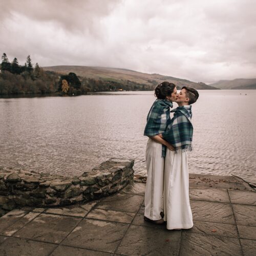 two brides kissing on the shores of a loch in Scotland on their Boreland Loch Tay wedding day