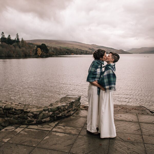 two brides kissing on the shores of a loch in Scotland on their Boreland Loch Tay wedding day