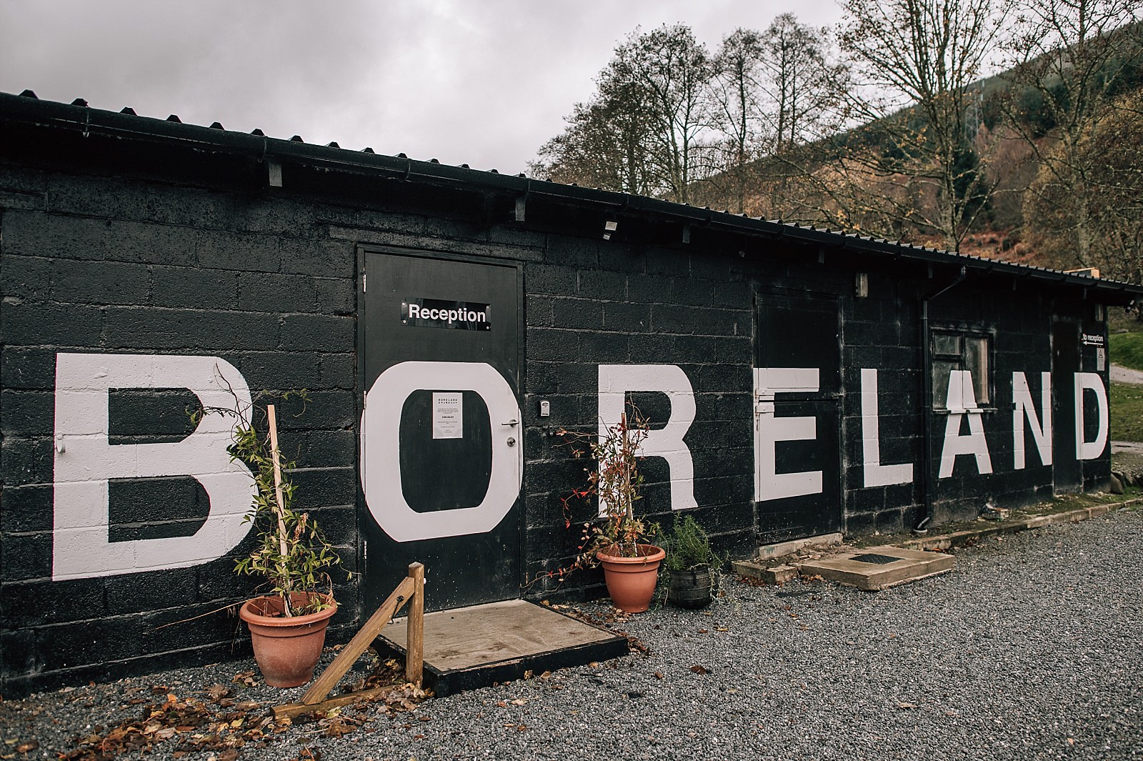 exterior of boreland loch tay wedding venue with big graffitti letters