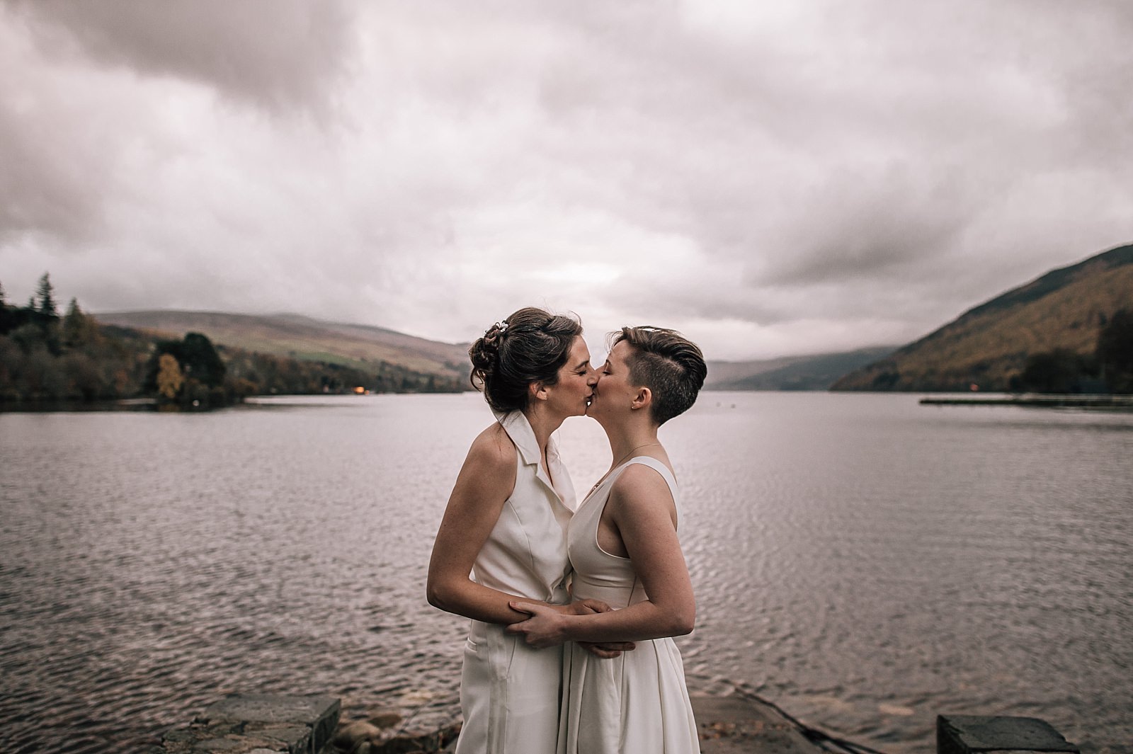 two brides kissing on the shores of boreland loch tay on their wedding day in perthshire scotland
