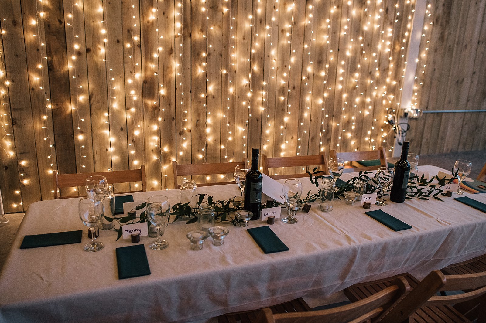 interior of boreland loch tay wedding venue set up for reception dinner wedding event with wooden tables and chairs and fairy lights