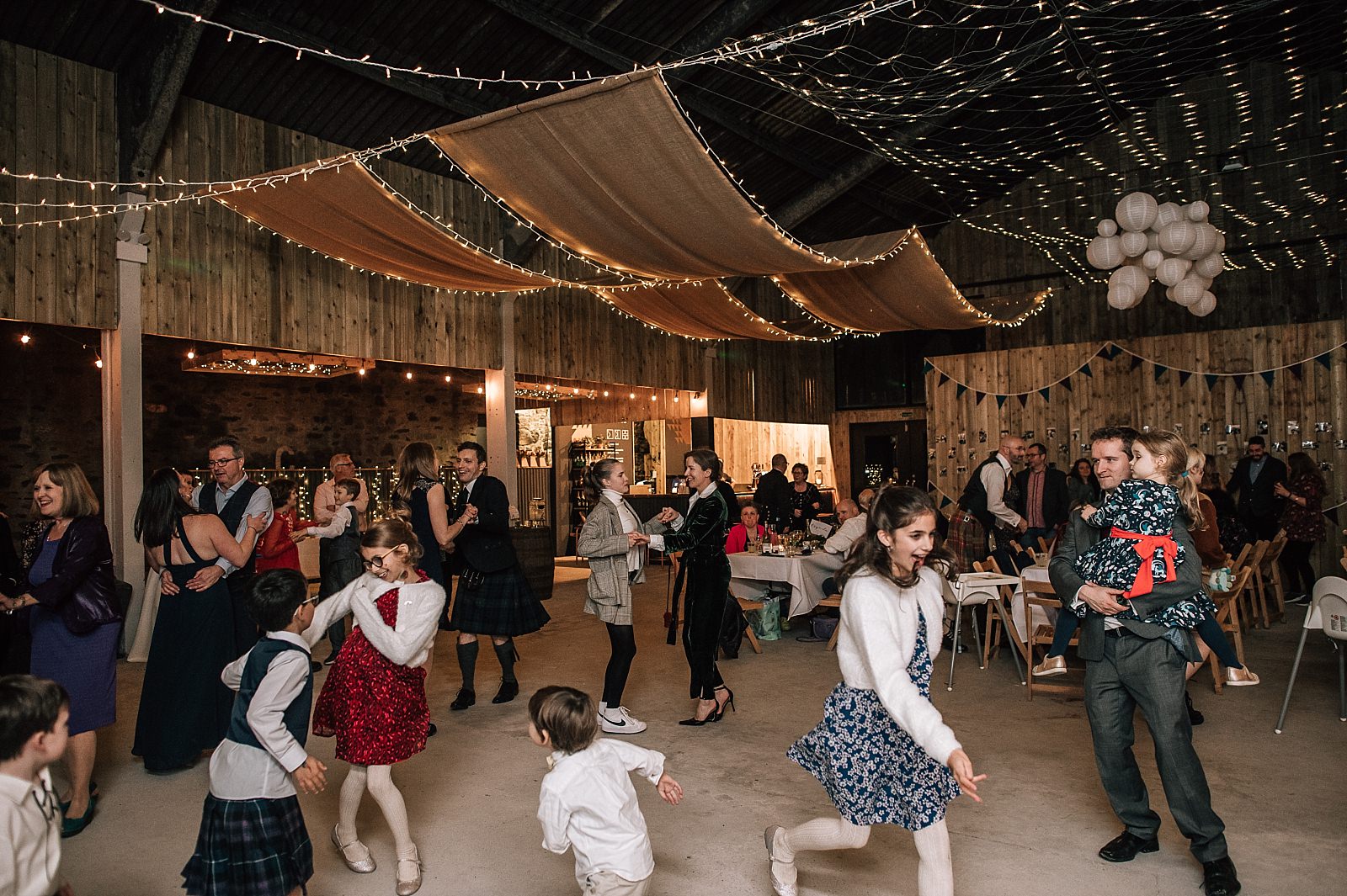 interior of boreland loch tay wedding venue set up for reception dancing ceilidh with fairy lights