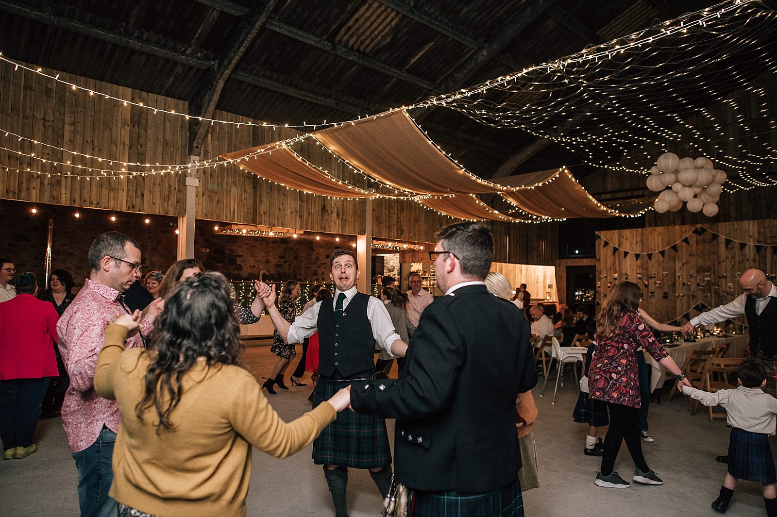 interior of boreland loch tay wedding venue set up for reception dancing ceilidh with fairy lights