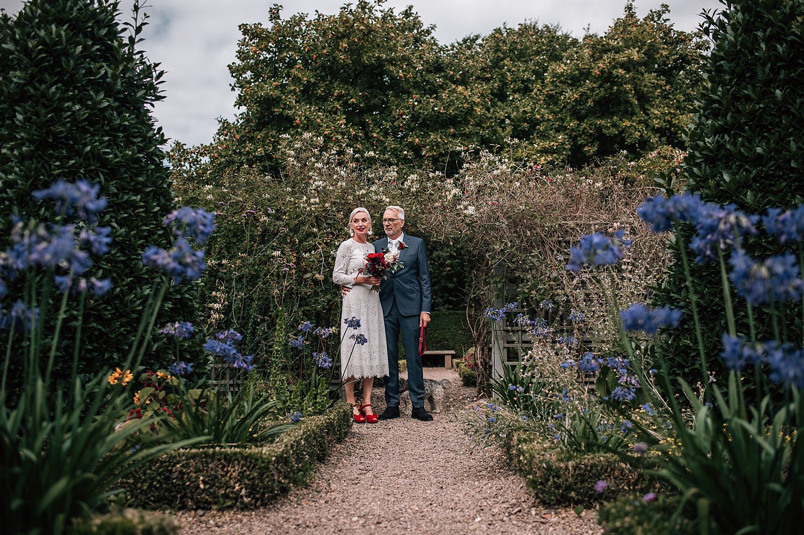 bride and groom pose for photos in gardens in edinburgh city centre on their elopement in scotland