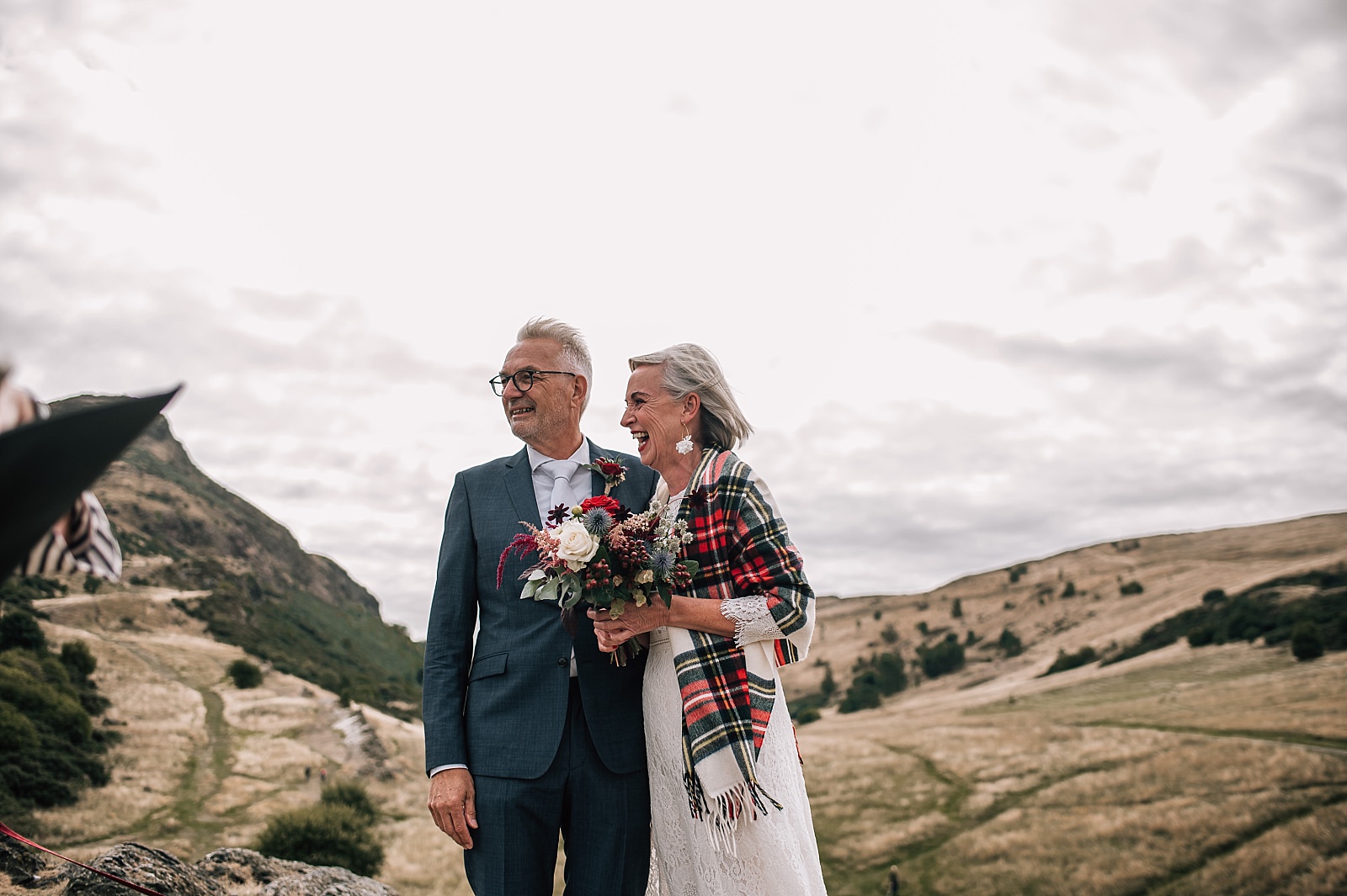 mature couple photographed by elopement photographer edinburgh at their wedding ceremony on arthurs seat scotland