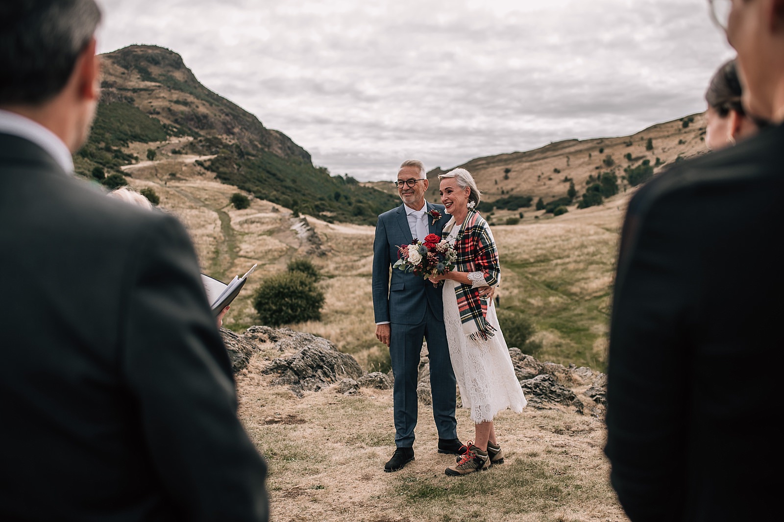 mature couple photographed by elopement photographer edinburgh at their wedding ceremony on arthurs seat scotland