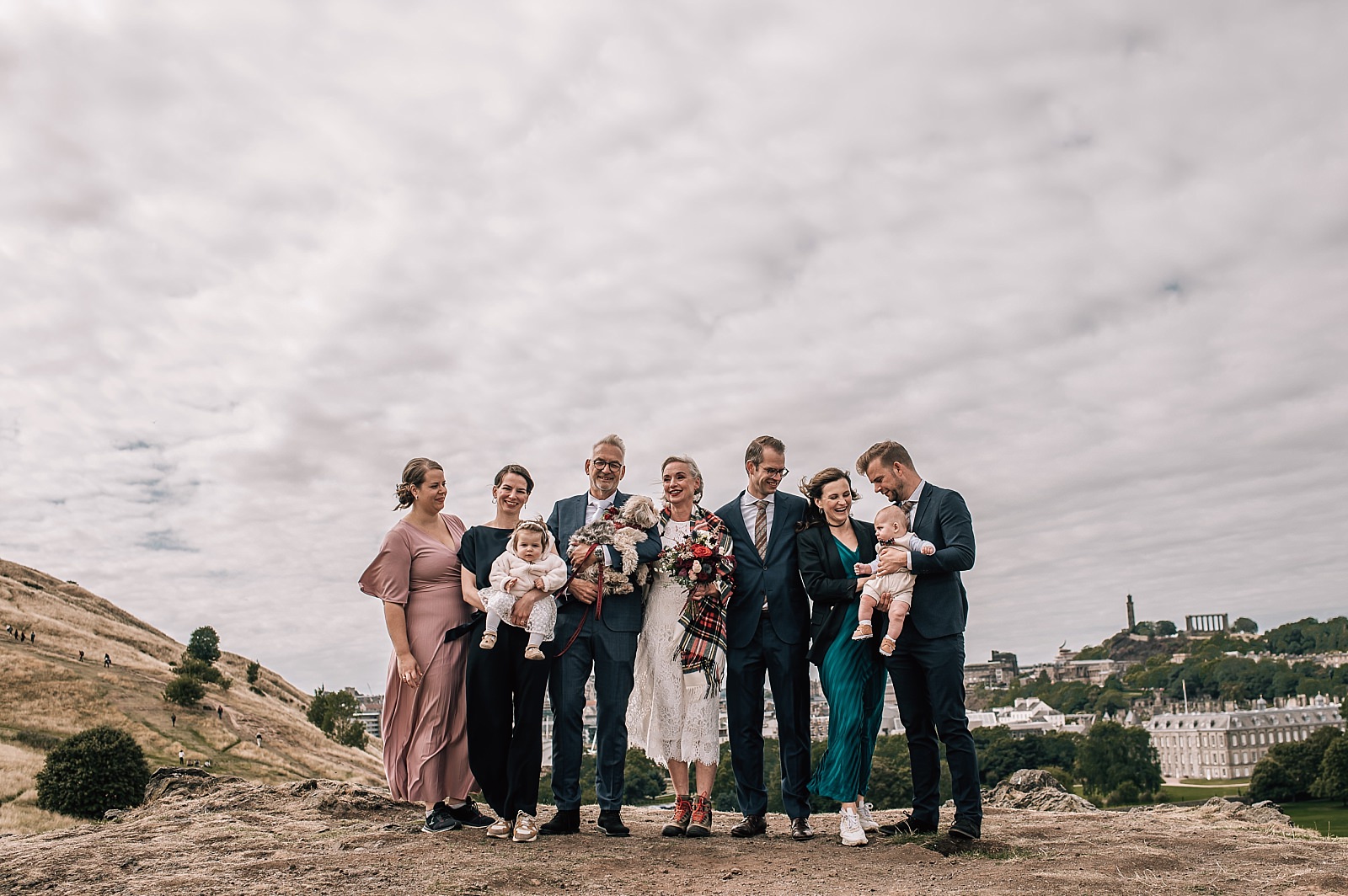 elopement photographer edinburgh captures outdoor wedding ceremony on st arthurs seat scotland with small group of guests