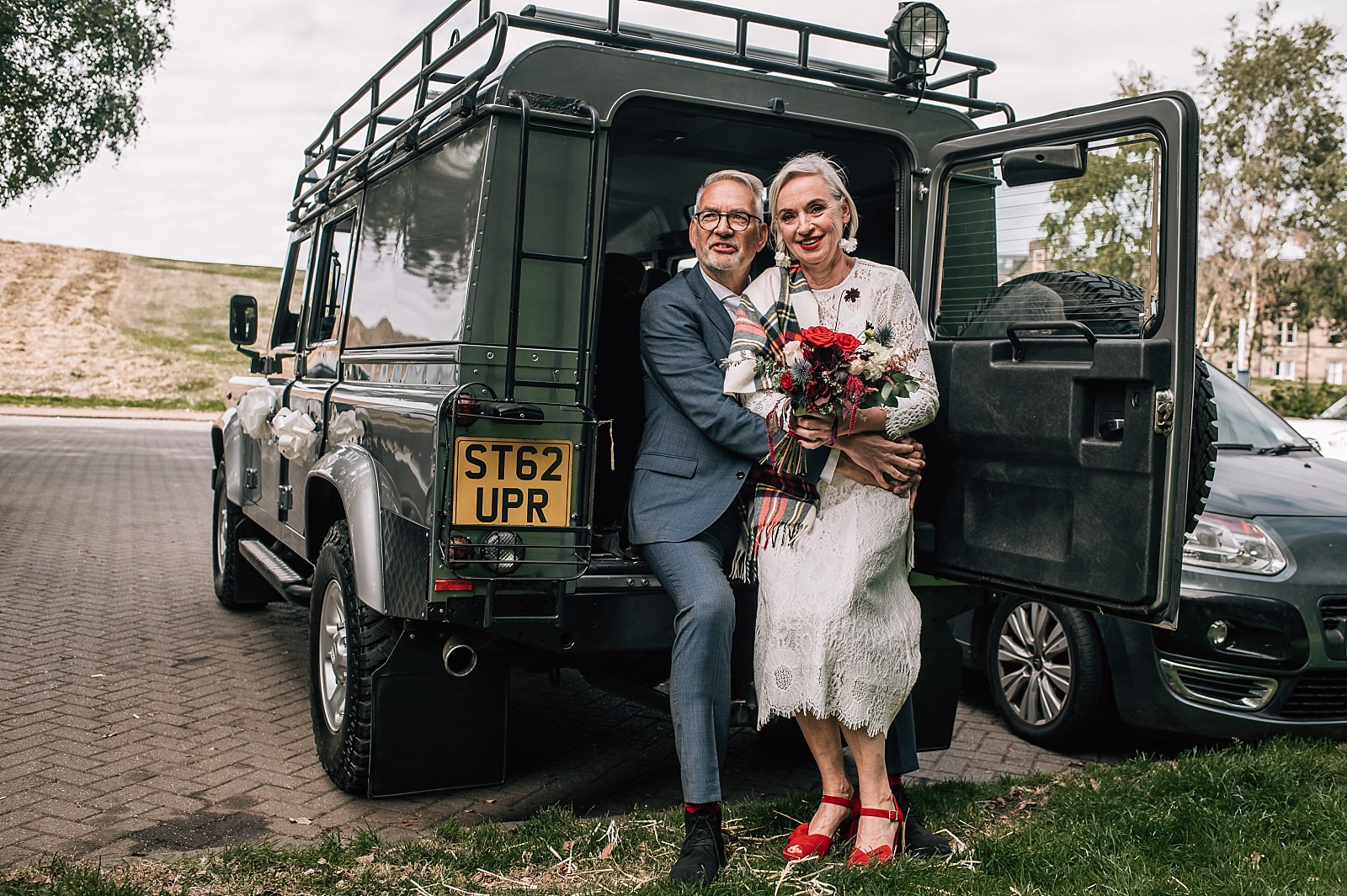 bride and groom cuddle in the back of landrover defender on their edinburgh elopement wedding day