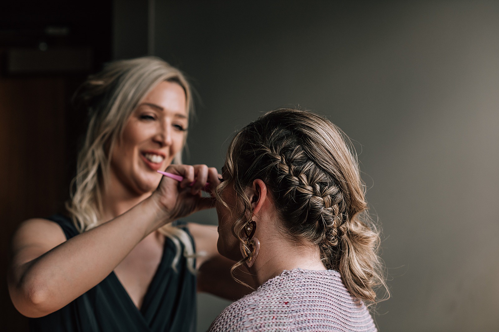bride getting her hair done in a beautiful plait by bridesmaid before her west brewery wedding