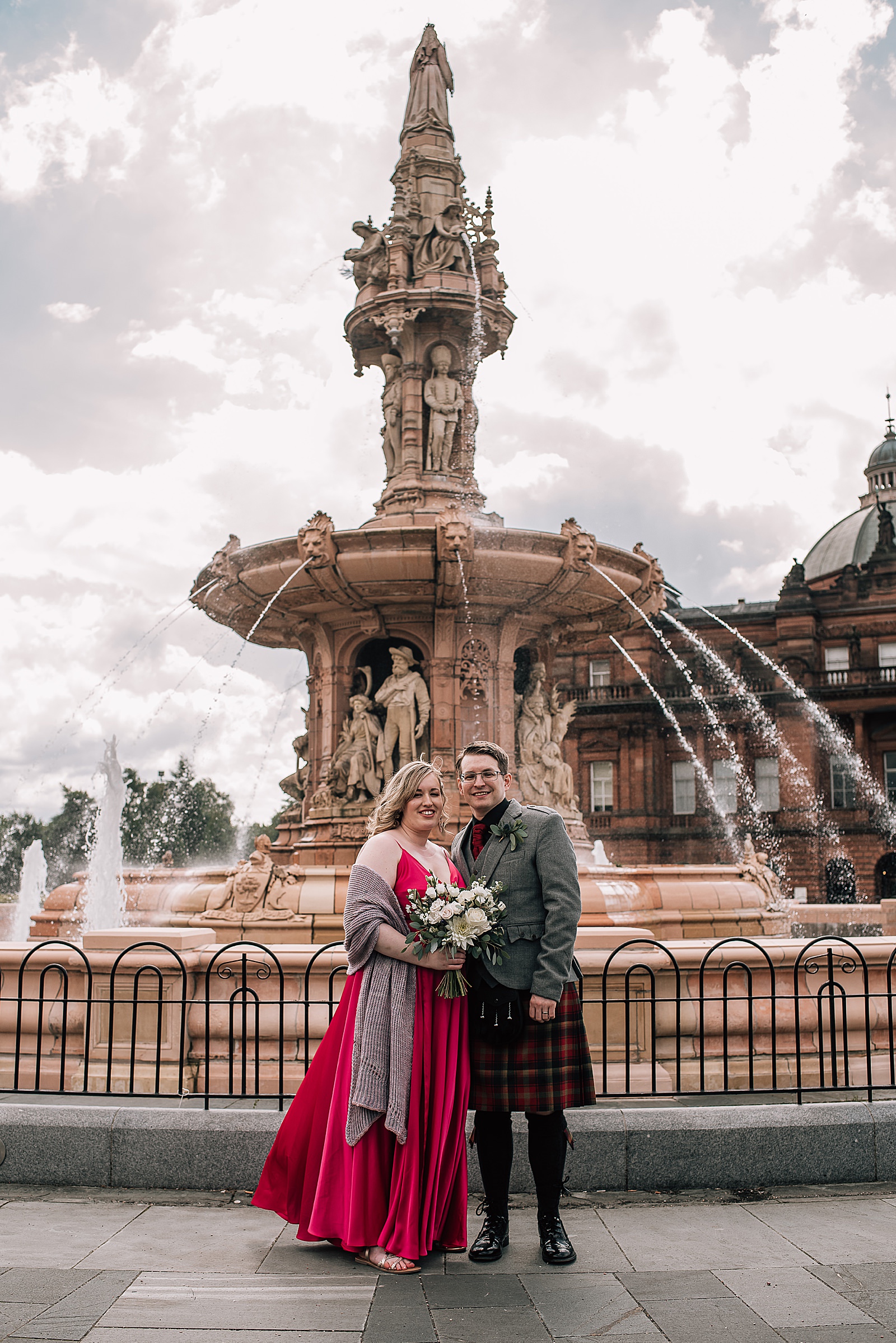 bride and groom standing in front of fountain at people's palace glasgow for wedding photos by alternative wedding photographer glasgow after this west brewery wedding