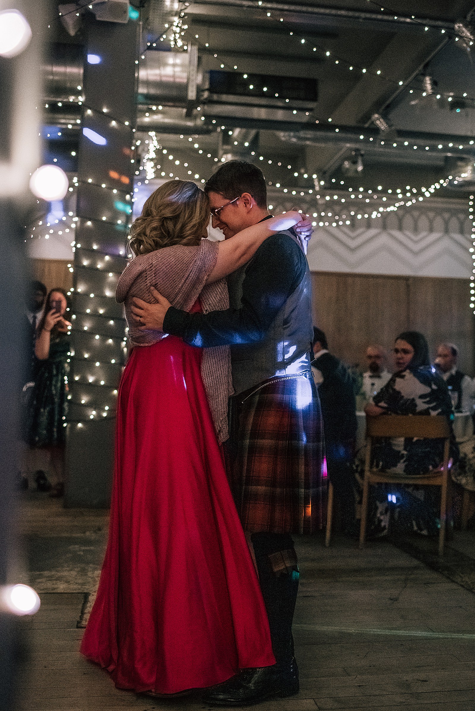 bride and groom during their first dance under twinkling fairy lights at west brewery wedding glasgow