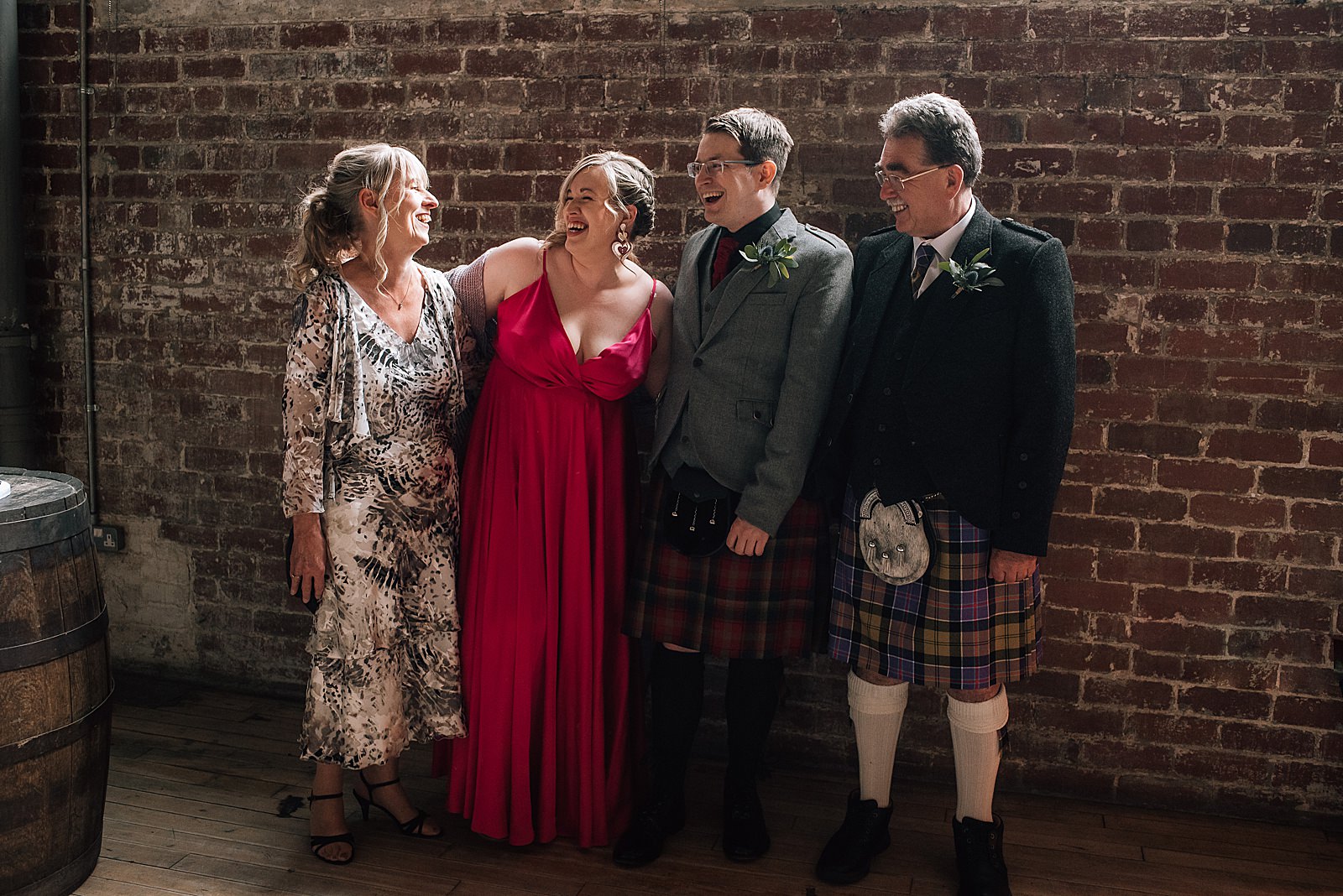 bride and groom with mother and father in family wedding portrait taken by alternative wedding photographer glasgow