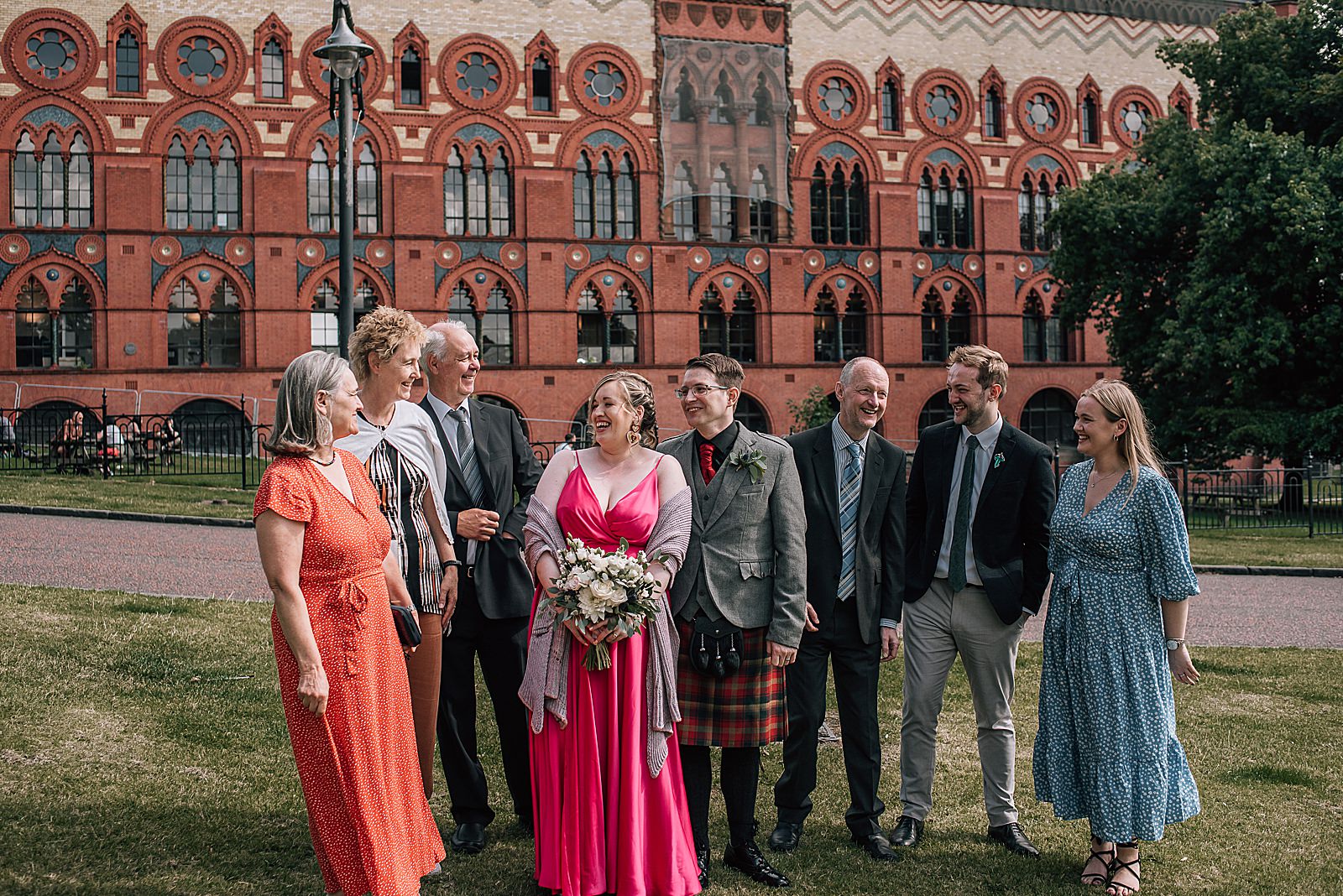 wedding guests standing outside west brewery glasgow for family portrait taken by alternative wedding photographer glasgow after west brewery wedding