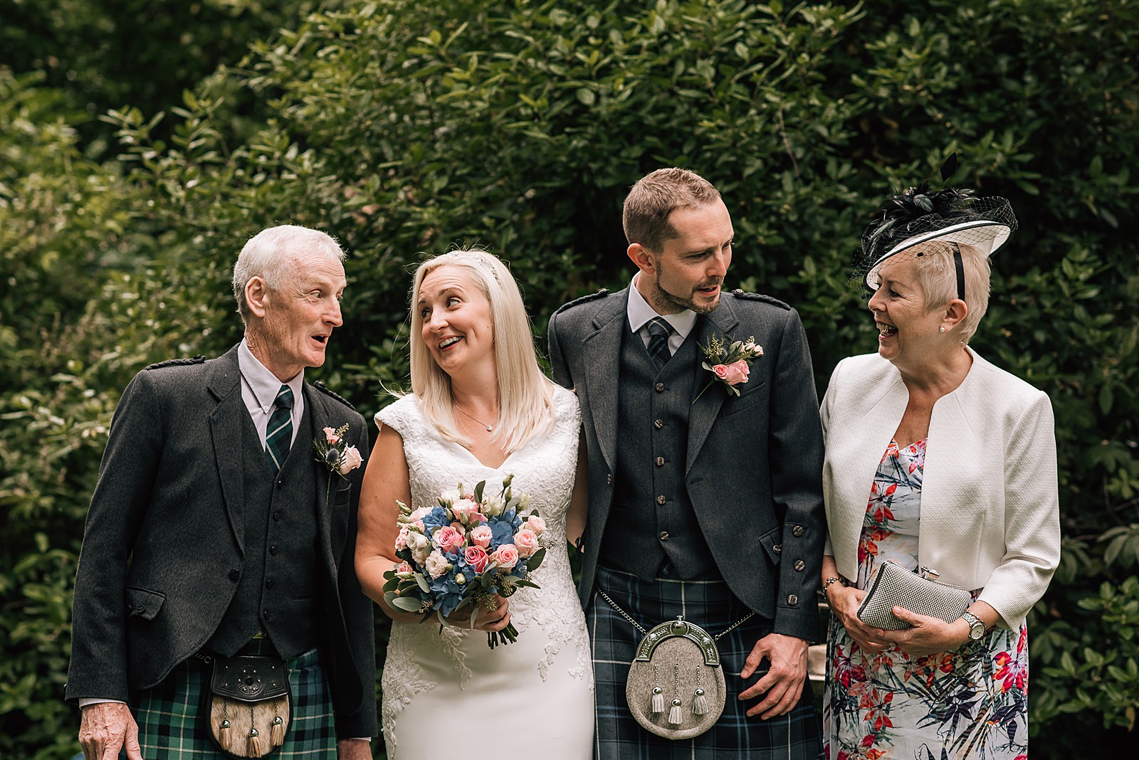 amily wedding portrait in glasgow garden with bride and groom and mother and father before their the bothy glasgow wedding