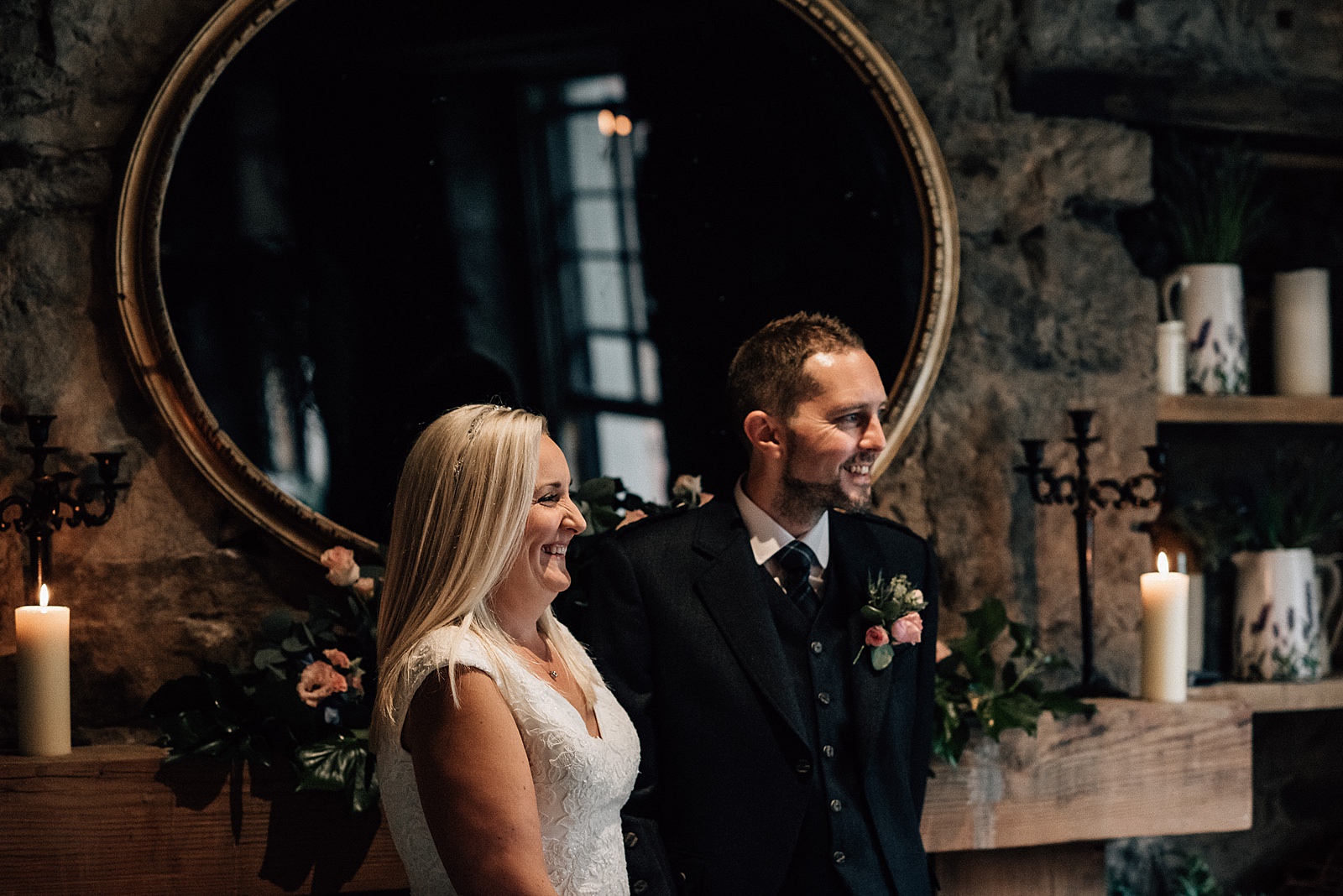 bride and groom smiling during their wedding ceremony in the scullery for their the bothy Glasgow wedding