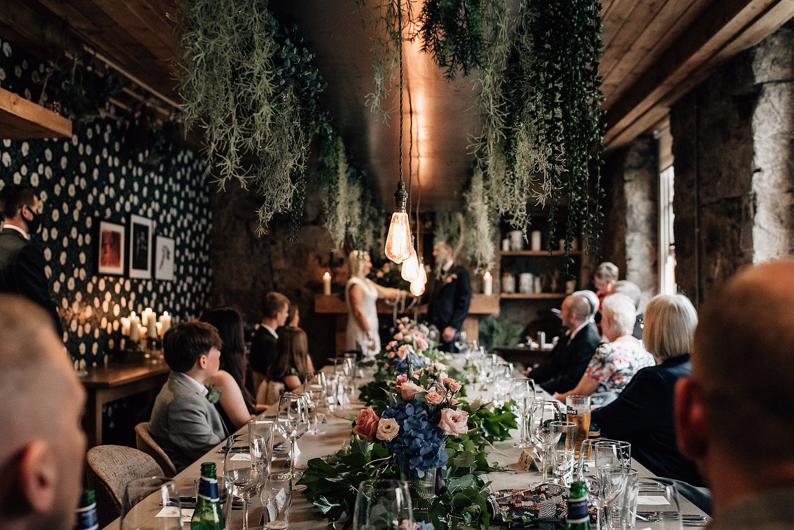 the bothy glasgow wedding ceremony set up with flowers, glassware, foliage and decorative lighting during west end wedding glasgow