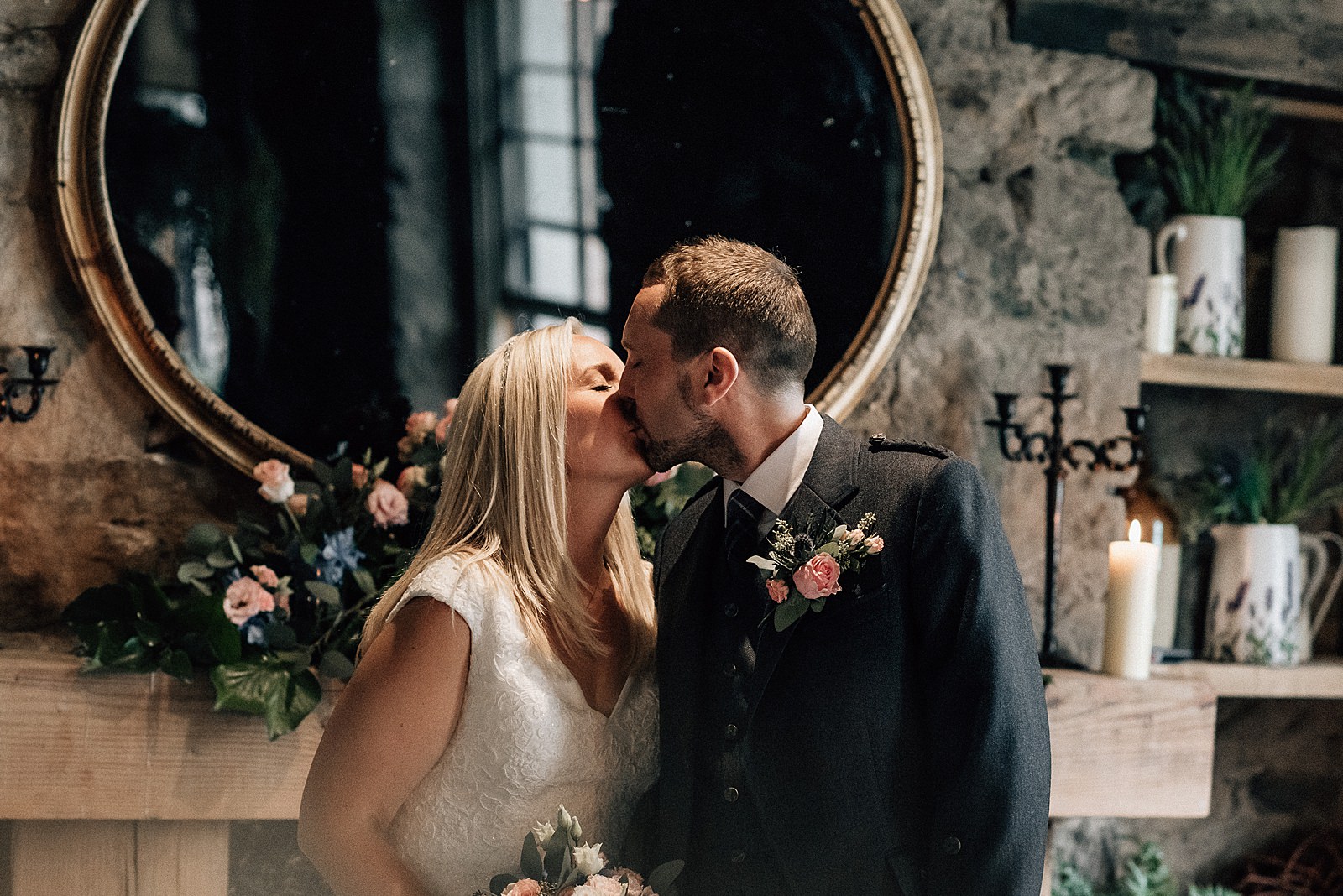 bride and groom's first kiss during wedding ceremony at the bothy glasgow wedding, a Scottish city wedding venue