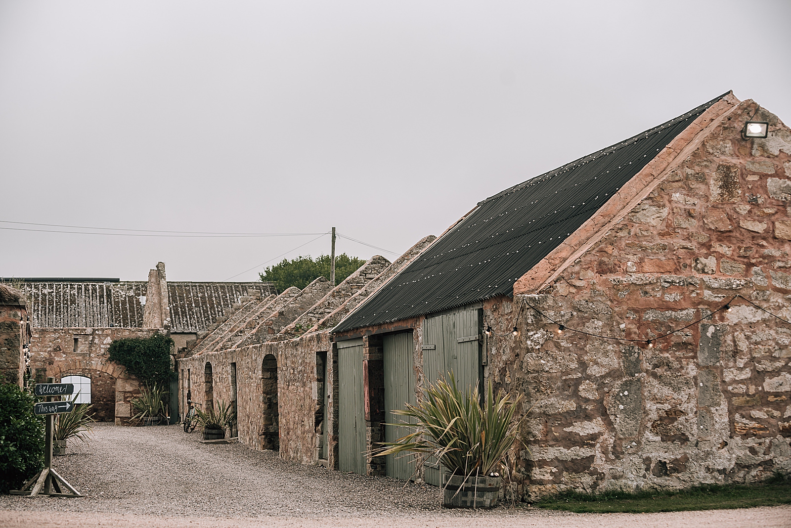 the cow shed scotland in crail on the morning of a diy Scottish wedding - rustic stone barns with green doors