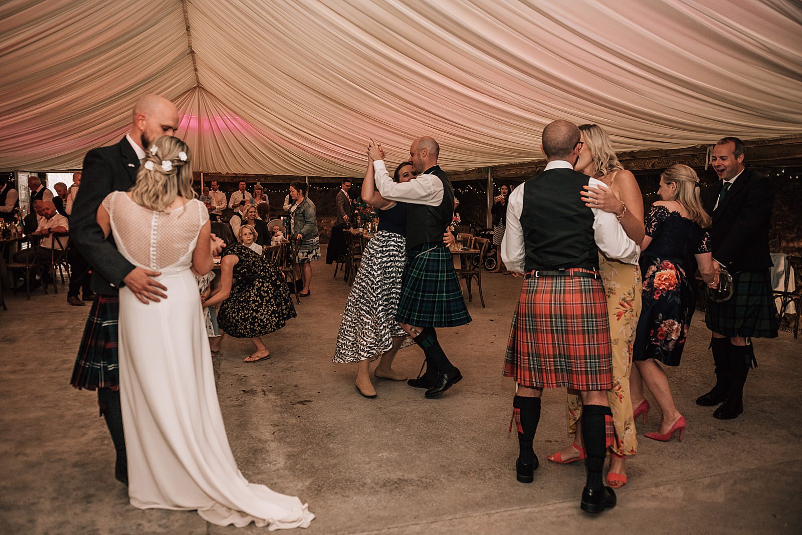 wedding guests dancing during wedding reception at the cow shed scotland
