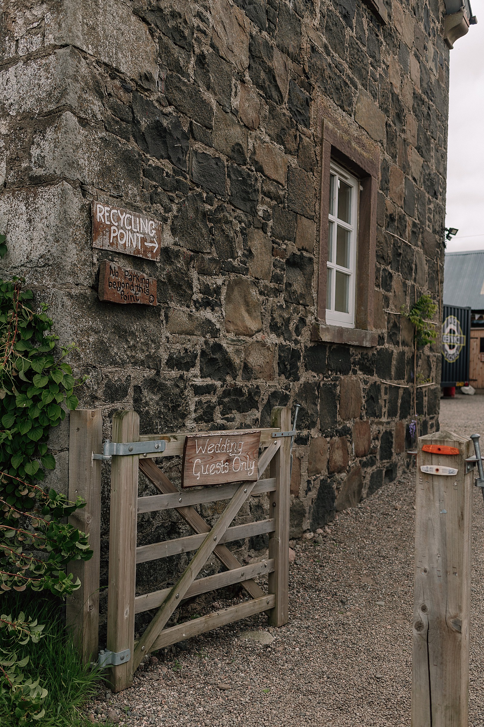 entrance of comrie croft wedding venue with wedding guests only sign on gate of stone farmhouse