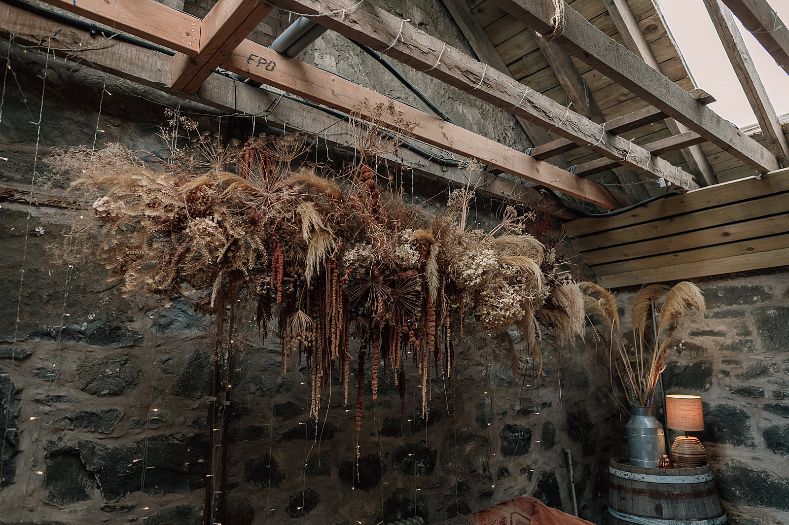 a large hanging dried flower installation for a wedding at Comrie Croft one of the best Scottish barn wedding venues in scotland