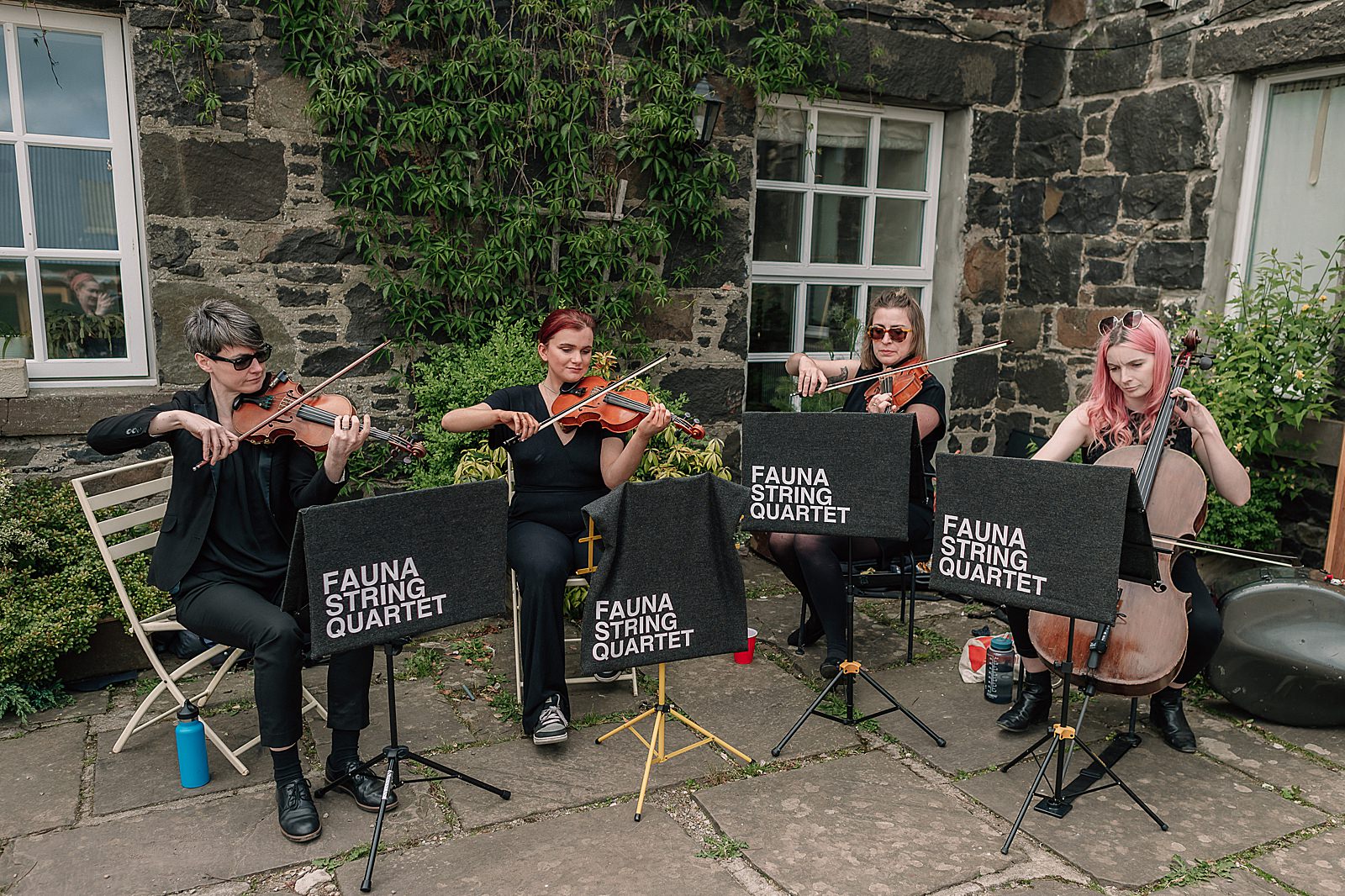 fauna string quartet playing at Comrie Croft wedding on a sunny day