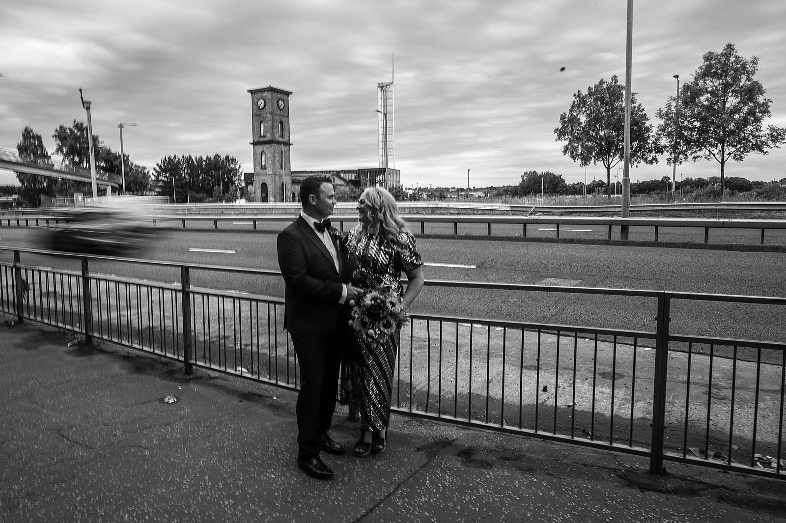 bride and groom standing by clydeside expressway for their quirky glasgow wedding at clydeside distillery
