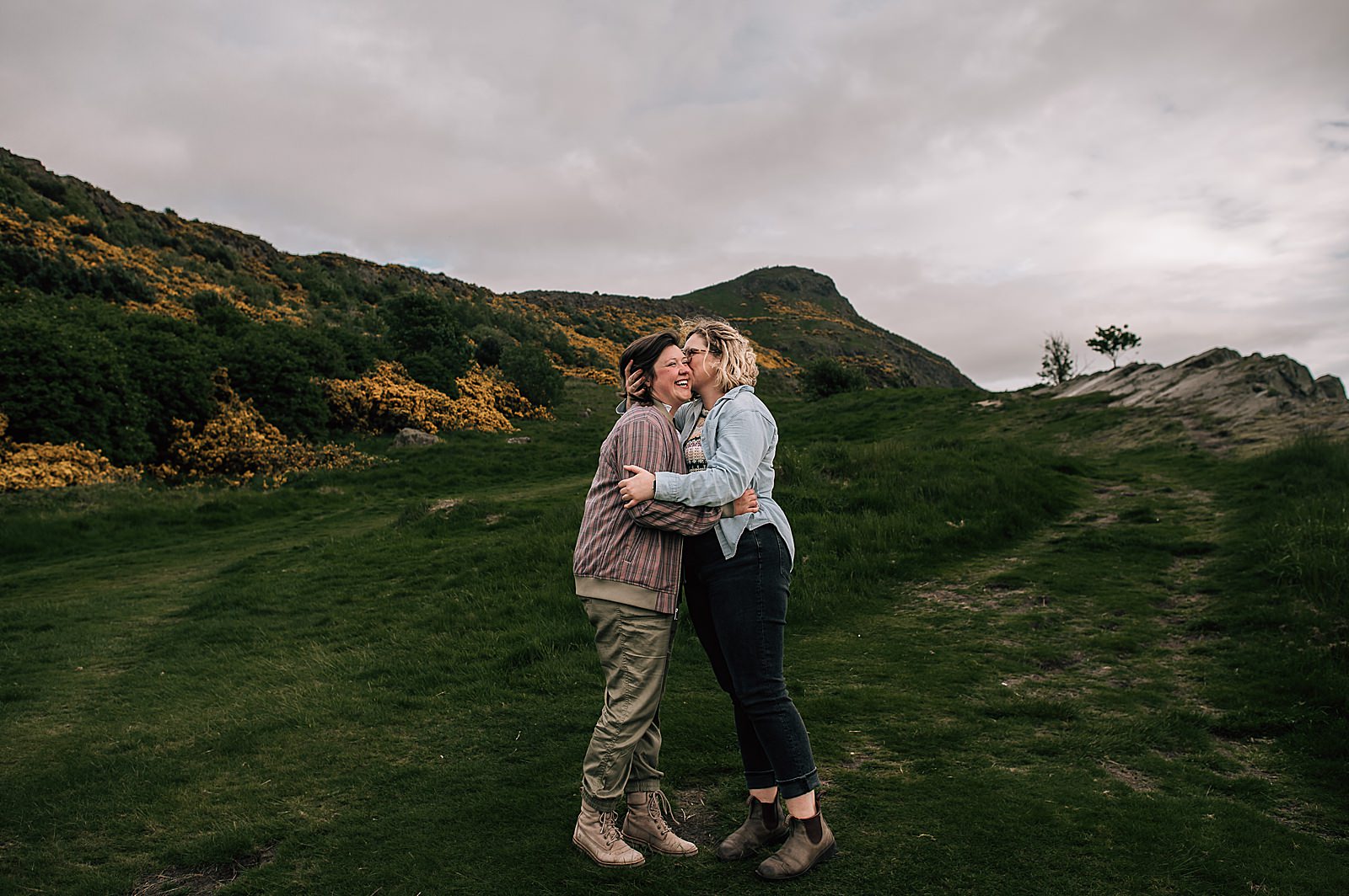 couple hugging and smiling after their lgbtq+ engagement photography shoot Edinburgh