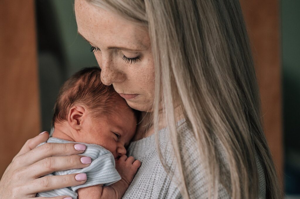 mother cuddling baby close to her chest