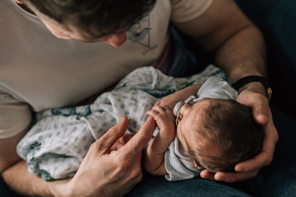 father holding newborn baby