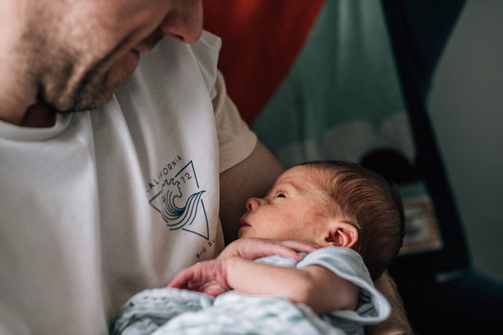 baby looking at father