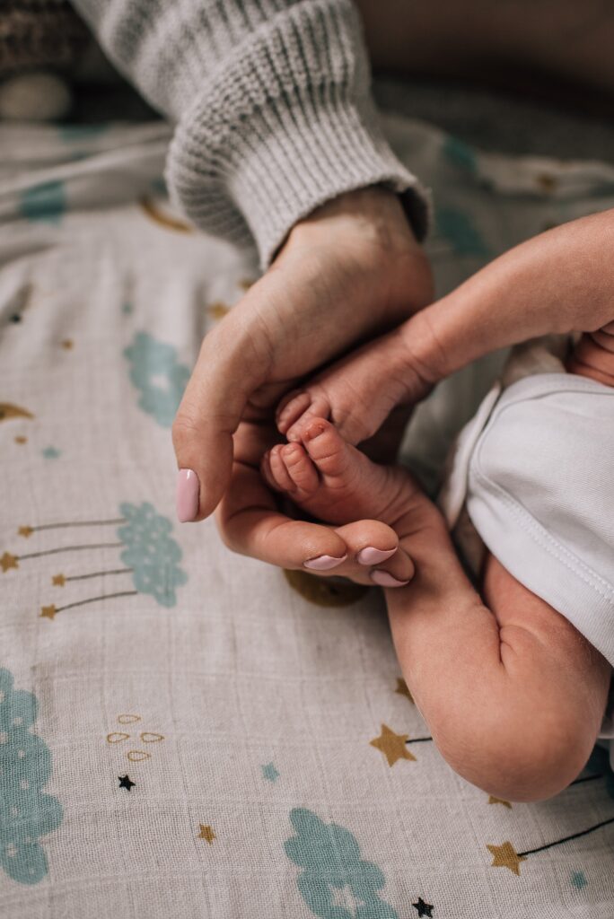 mother cradling baby feet
