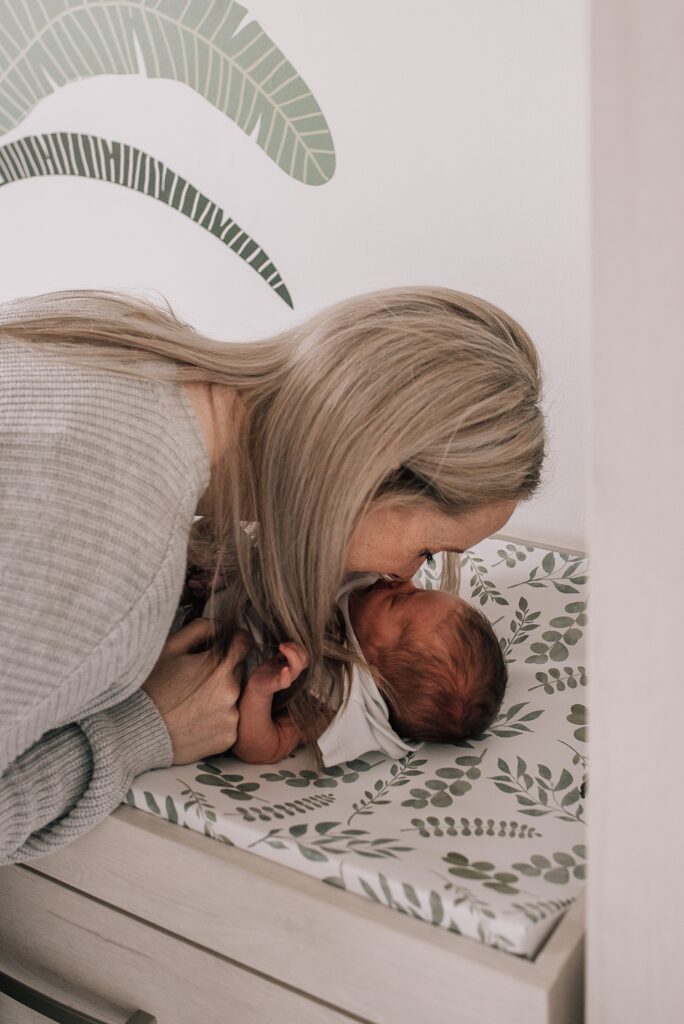mother nuzzling newborn baby