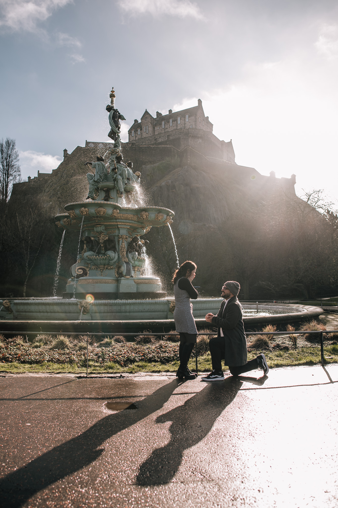 man down on one knee proposing to girlfriend in front of Ross Fountain, Edinburgh | proposal photography