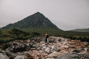 lgbtq couple kissing in front of a mountain Glencoe, Scotland